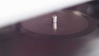 Close-up of spinning vinyl record on turntable spindle