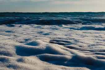 Close-up of white sea foam on ocean waves