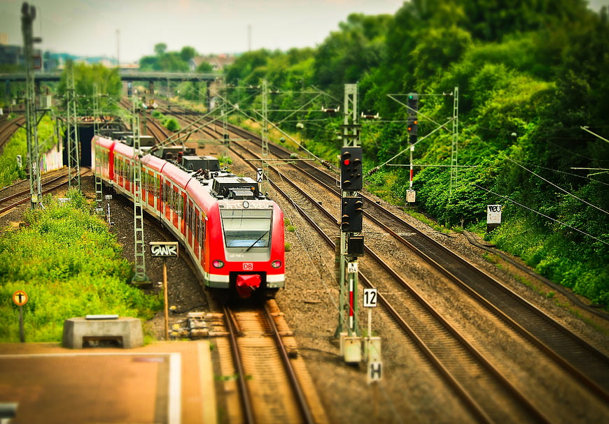 Red DB train on railway tracks with tilt-shift effect