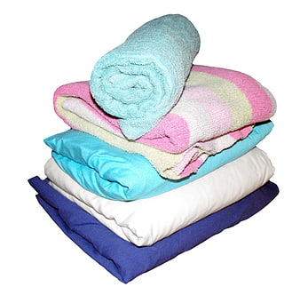 Stack of colorful folded towels and bedding on white background