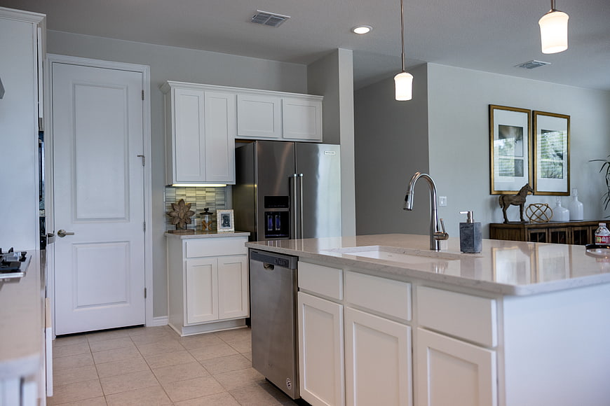 Modern White Kitchen with Island and Stainless Steel Appliances