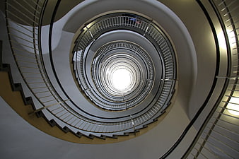 Low angle view of modern spiral staircase with metal railings