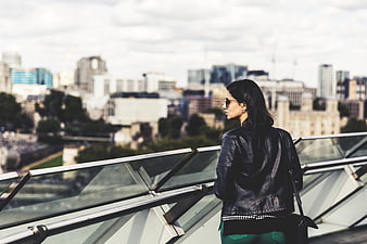 Woman in Leather Jacket Viewing London Cityscape
