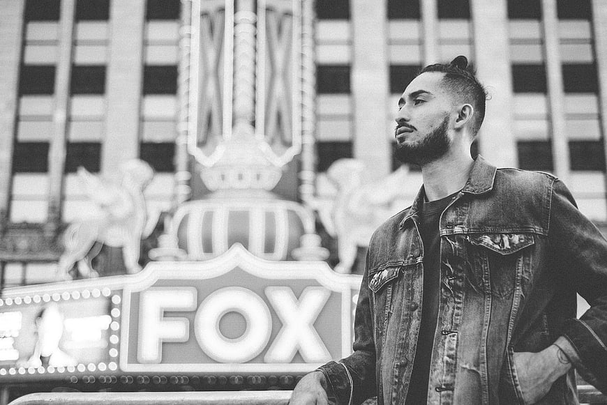 Man in Denim Jacket Standing in Front of Fox Theater Sign
