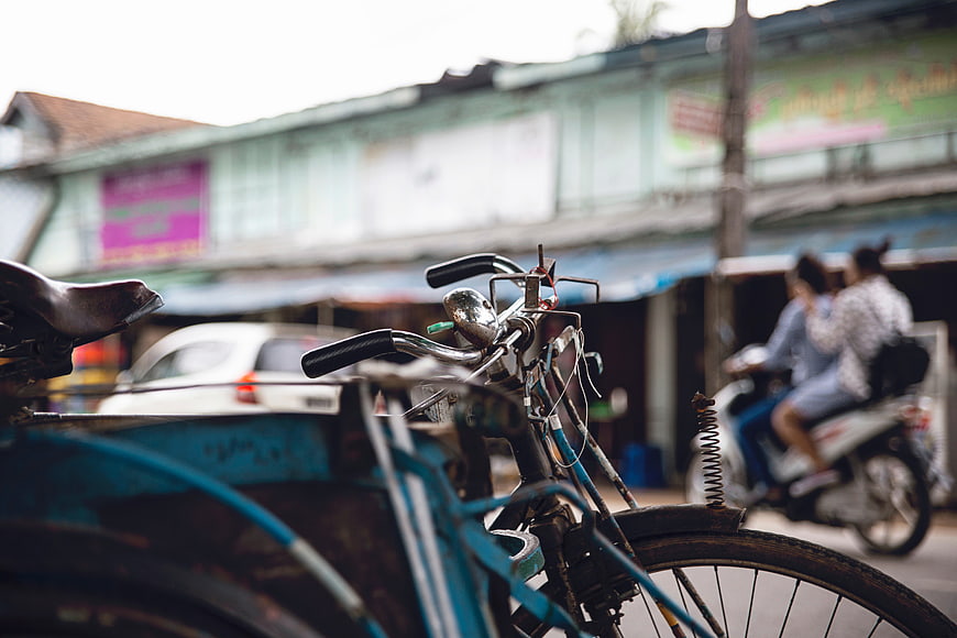 Close-up of vintage blue bicycle handlebars on street