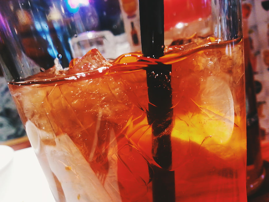 Close-up of Iced Tea with Lemon and Black Straw
