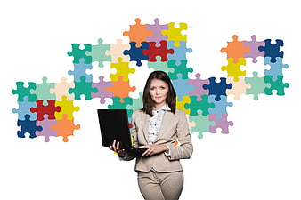 Businesswoman with laptop and colorful puzzle pieces background