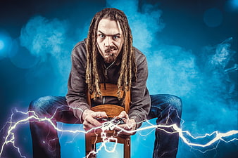 Angry gamer with lightning effects holding controller