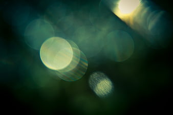 Abstract green bokeh light background with lens flare