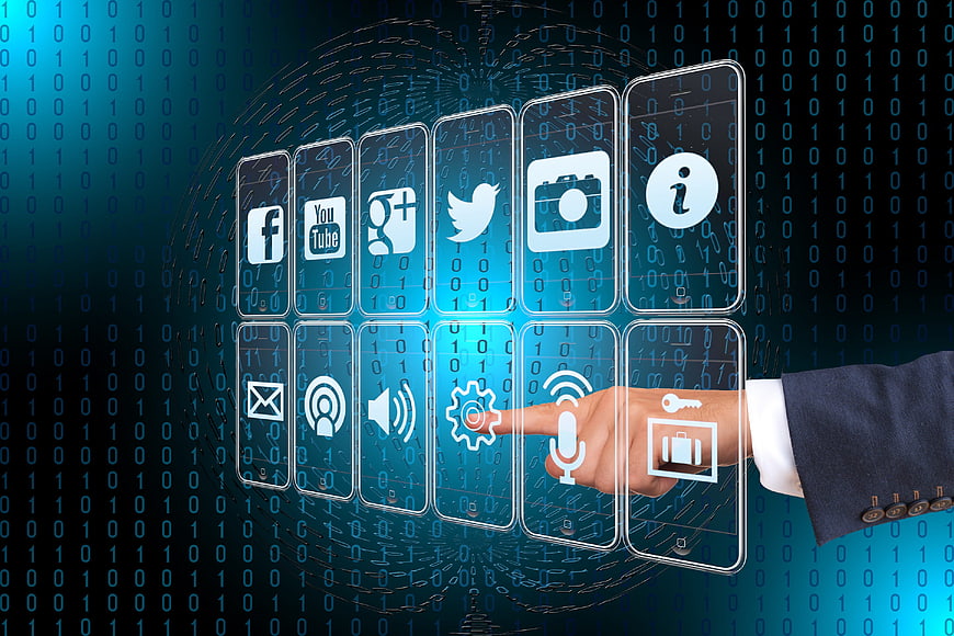 Businessman touching digital interface with social media icons
