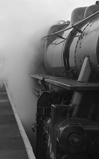 Vintage Steam Train Engine with Smoke on Railway Platform