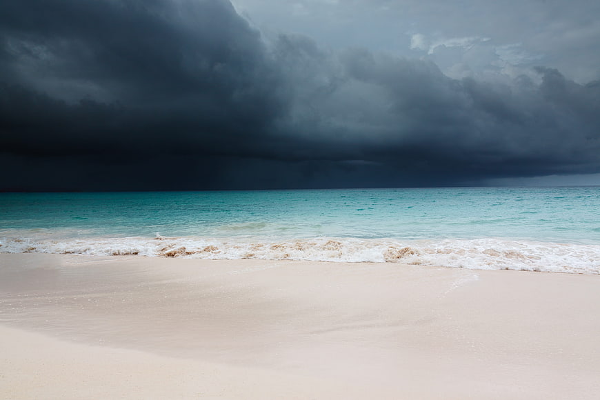 Dramatic Dark Storm Clouds Over Turquoise Tropical Beach