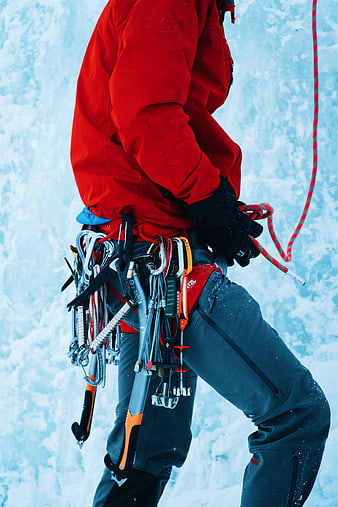 Ice Climber with Gear on Snowy Mountain Wall