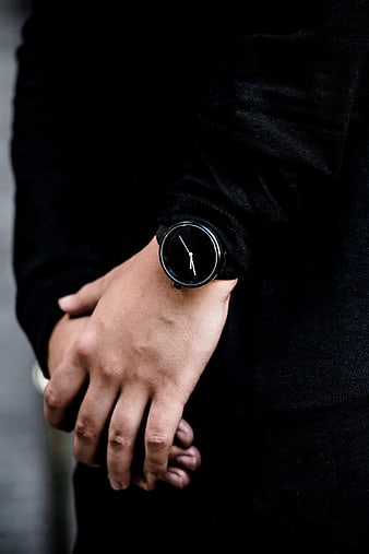 Minimalist black wristwatch on man's wrist