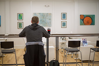 Man working at high table in modern office with art