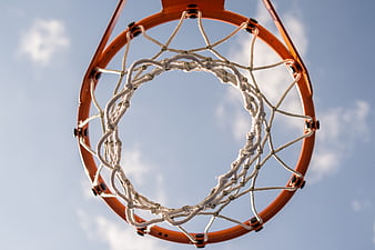Low angle view of basketball hoop and net against blue sky