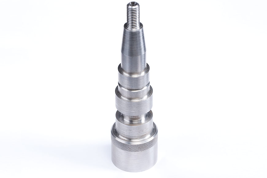 Precision machined metal shaft with threaded tip on white background
