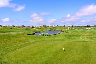 Scenic Wide View of a Lush Green Golf Course with Water Hazard