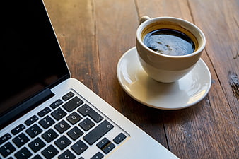 Laptop and Coffee Cup on Wooden Table