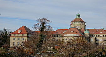 Historic Building with Red Roof and Green Dome in Munich