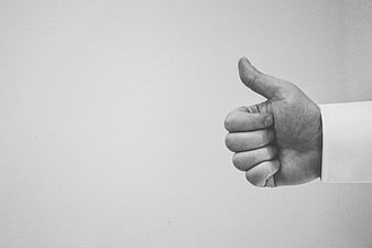 Black and white hand giving thumbs up gesture