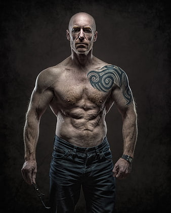 Shirtless Muscular Man With Tribal Tattoo And Dark Background