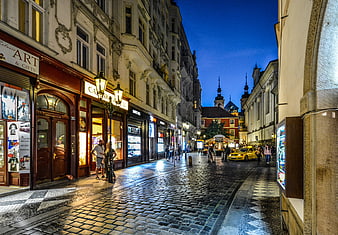 Cobblestone European Street At Dusk With Historic Architecture And Blue Sky