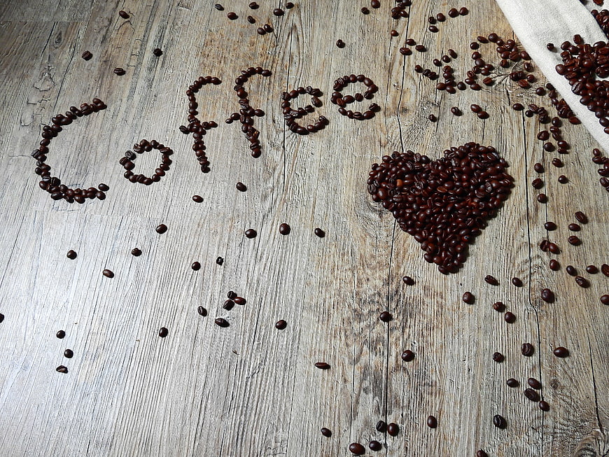 Coffee beans spelling love on rustic wooden background