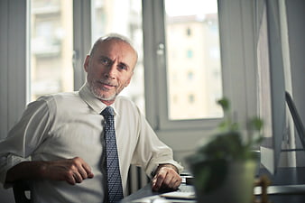 Senior Businessman Smiling at Office Desk