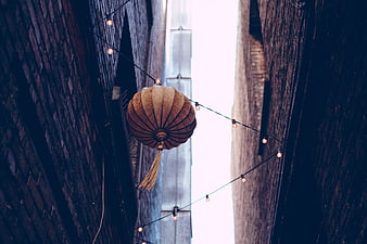Traditional Lantern Hanging in Narrow Alleyway with String Lights
