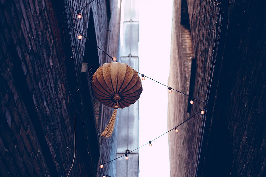 Traditional Lantern Hanging in Narrow Alleyway with String Lights