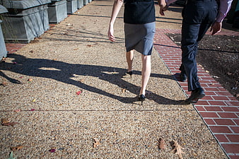 Business Couple Walking Away on Sidewalk