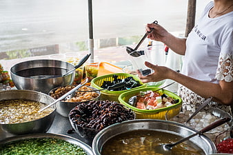 Vietnamese street food vendor preparing traditional sweet dessert Che