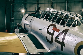 Vintage Silver Airplane in Hangar with Cockpit Canopy