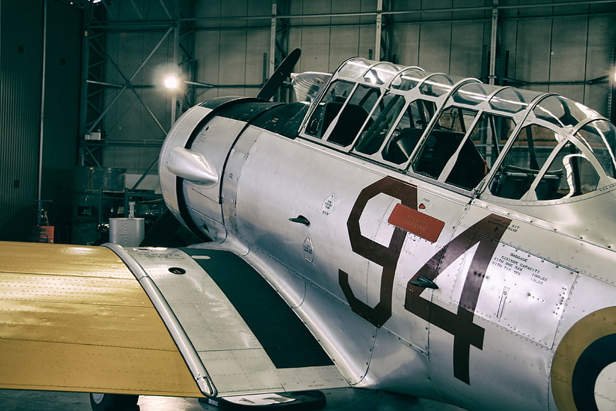 Vintage Silver Airplane in Hangar with Cockpit Canopy