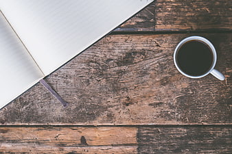 Top View of Open Notebook and Coffee Cup on Rustic Wood