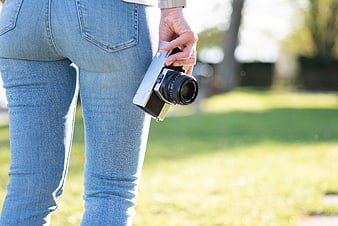 Woman holding vintage camera in park