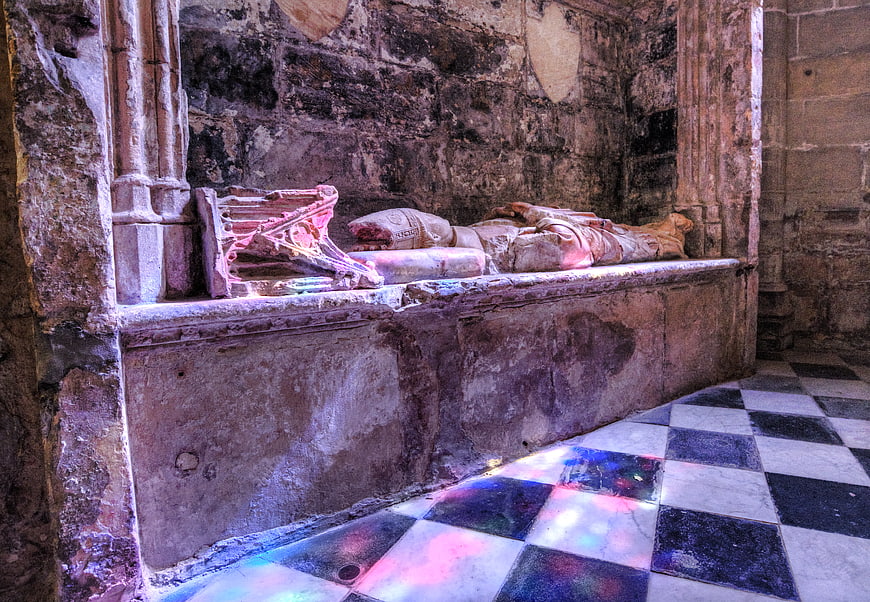 Ancient stone tomb effigy in historic church interior