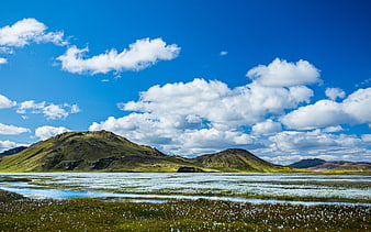 Scenic Icelandic Landscape with Green Hills and Blue Sky