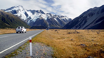 White Pickup Truck Driving on Scenic Mountain Road