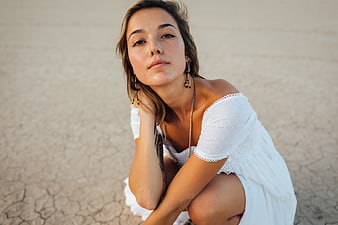 Portrait of Woman in White Dress on Desert Ground