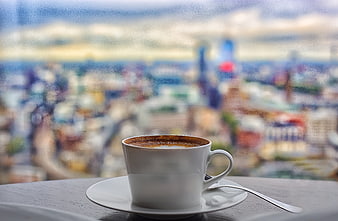 Coffee cup with blurred London cityscape background