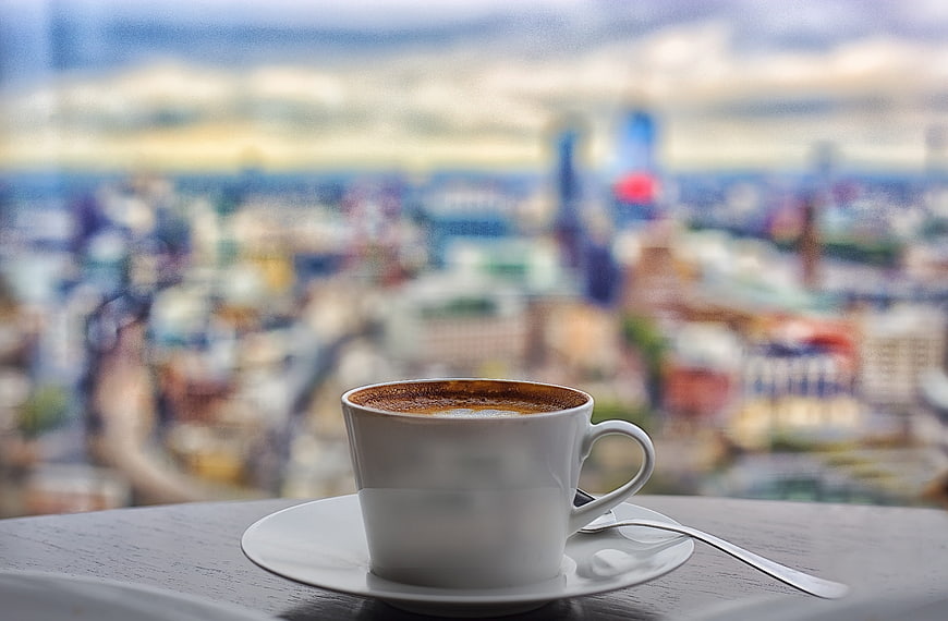 Coffee cup with blurred London cityscape background
