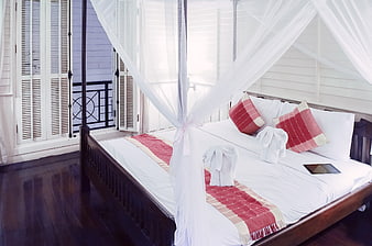 Luxury Hotel Bedroom with Four-Poster Canopy Bed and Towel Animals