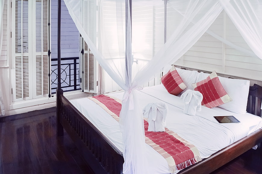 Luxury Hotel Bedroom with Four-Poster Canopy Bed and Towel Animals
