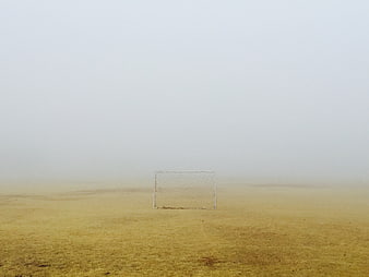Lone Soccer Goal in Foggy Field