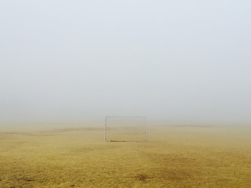 Lone Soccer Goal in Foggy Field