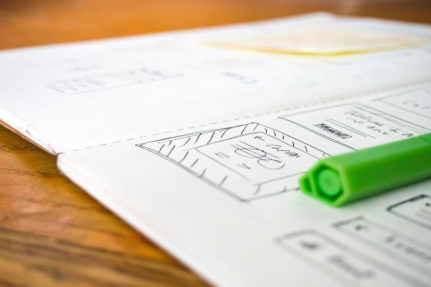 UX Wireframe Sketch in Notebook with Green Pen