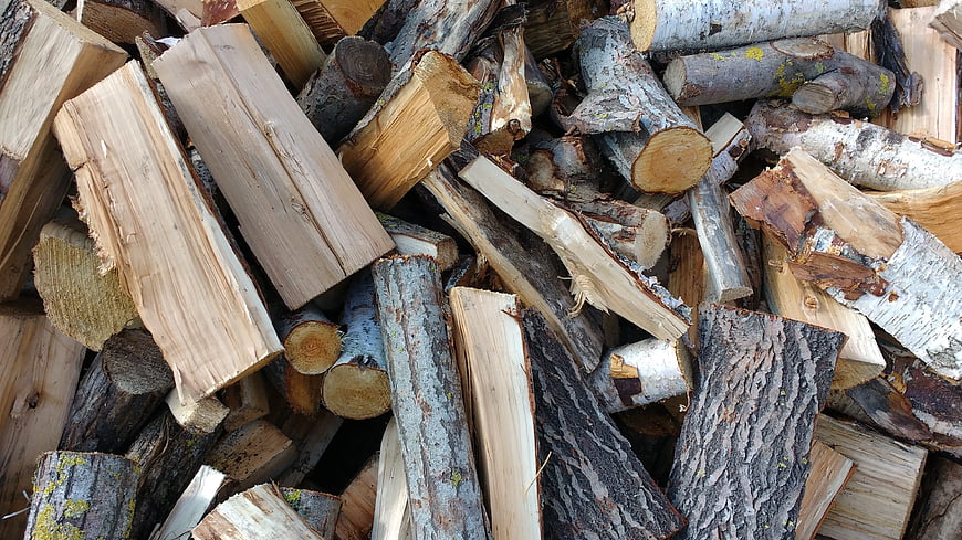 Pile of Split Firewood Logs with Bark