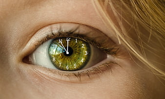 Close-up of green eye with clock face iris concept